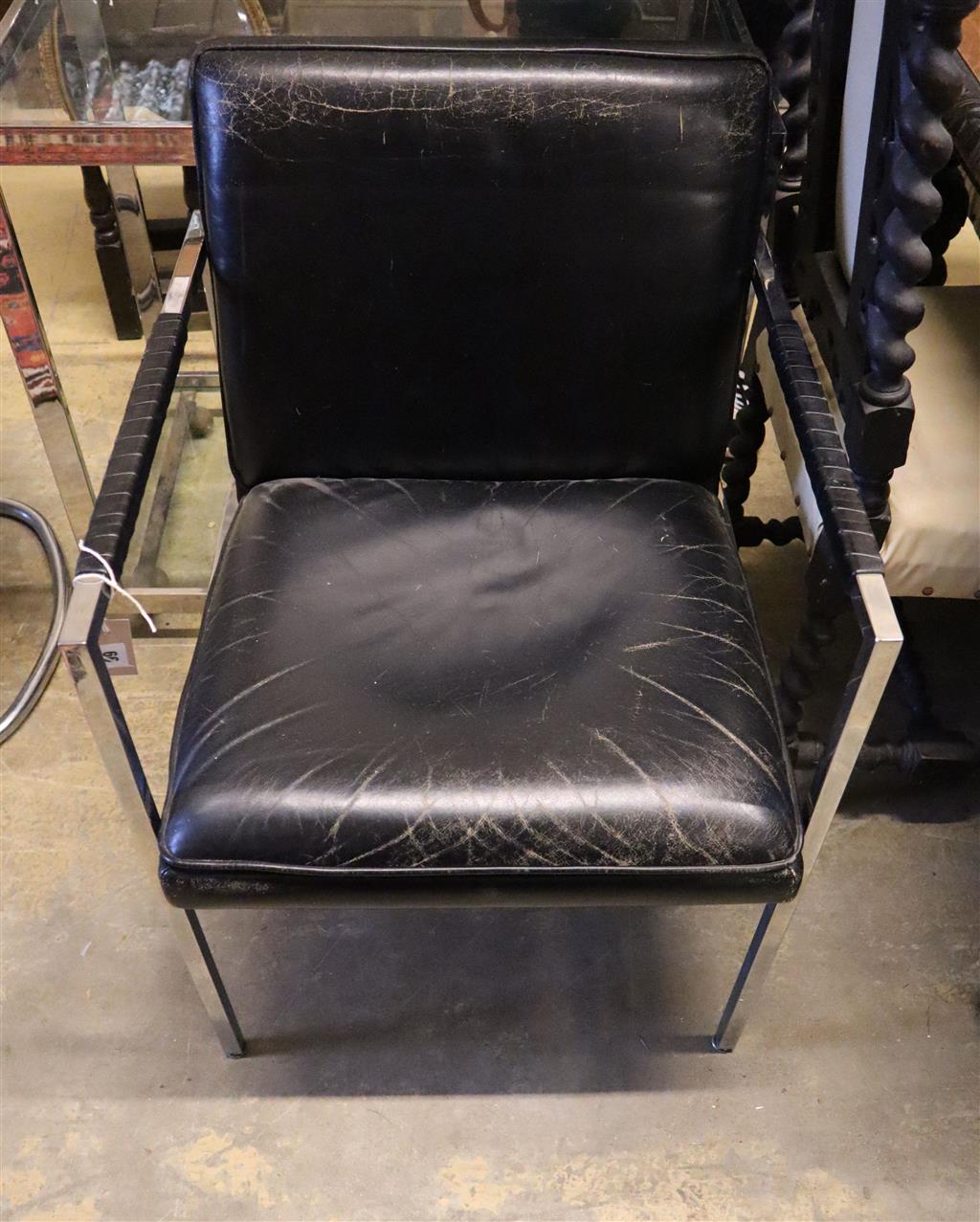 A contemporary chrome and black leather elbow chair